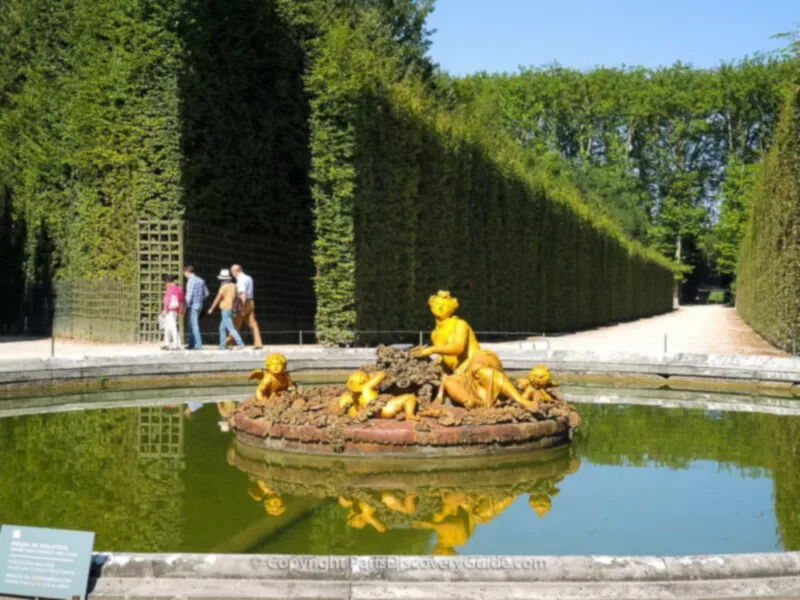 The Flora Fountain, at the crossroads of several Groves, wears a floral crown and is surrounded by flowers as Flora is the Roman goddess of flowers